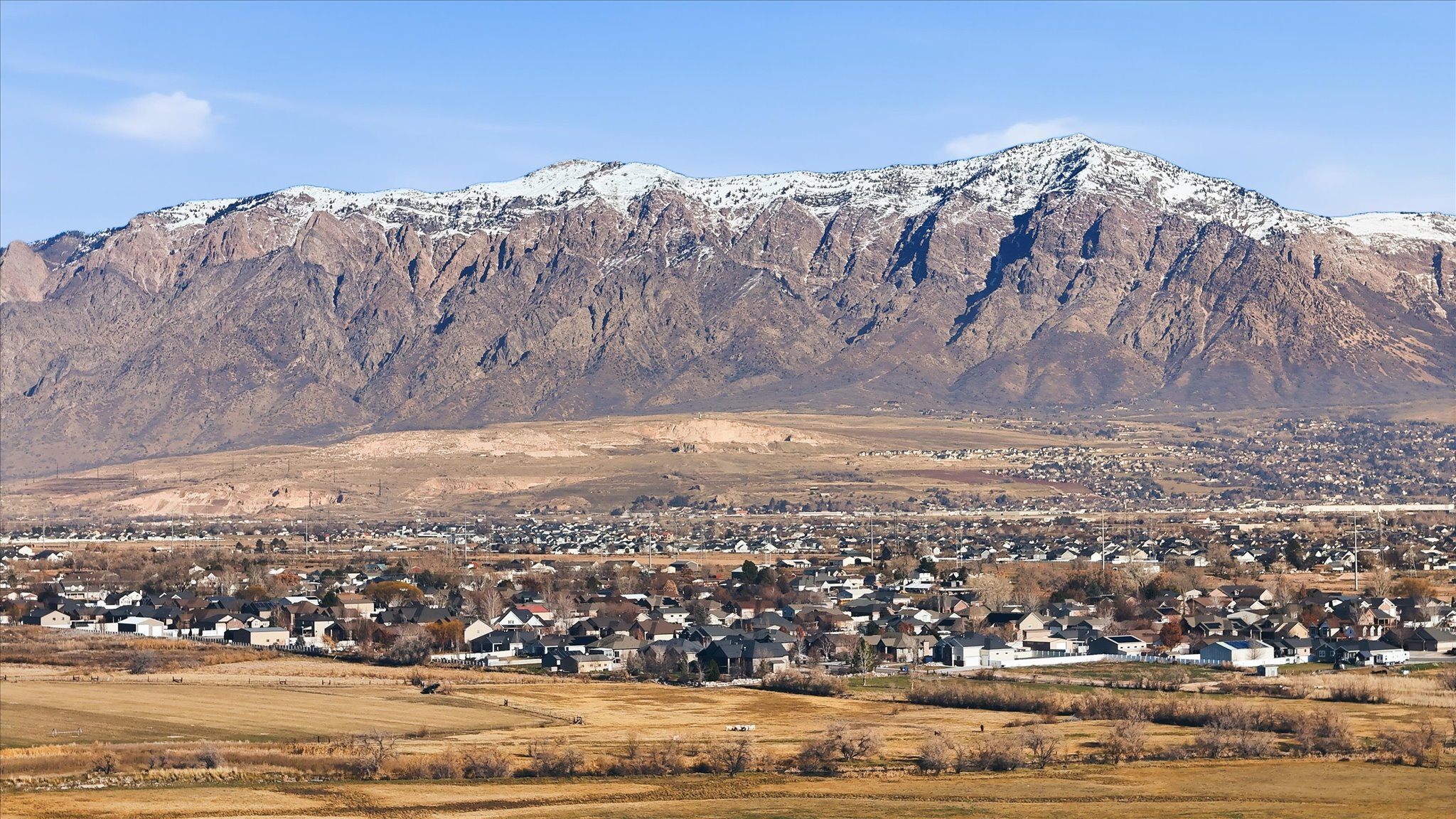 View of mountain backdrop with nearby suburban area