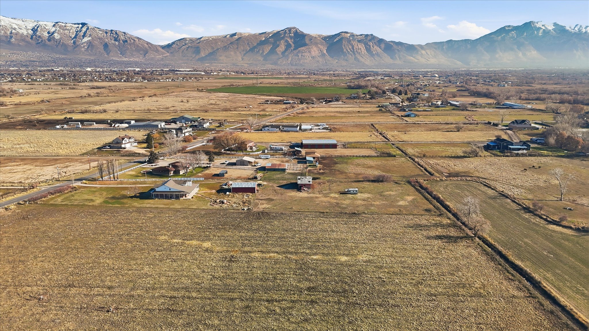 Aerial view of property and surrounding area with a mountainous background and rural landscape