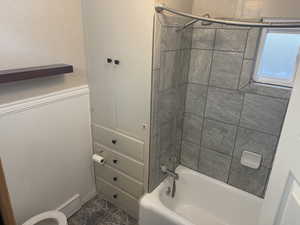 Bathroom featuring bathing tub / shower combination and toilet