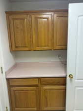 Kitchen featuring brown cabinets and light countertops