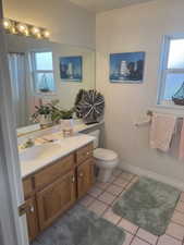 Bathroom featuring vanity, light tile patterned floors, and a shower with curtain