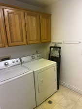 Laundry area with cabinet space and washer and dryer