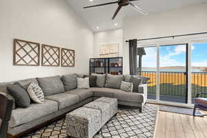 Living area featuring a water view, light wood-style flooring, ceiling fan, and recessed lighting
