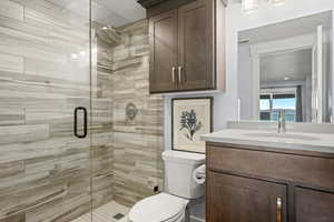 Bathroom featuring a stall shower and vanity