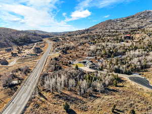 Aerial view of property and surrounding area with a mountainous background