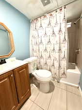 Bathroom featuring shower / bath combo with shower curtain and vanity