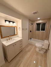 Full bath featuring vanity,  shower combination, and light wood-style floors
