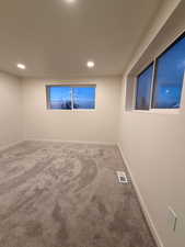 Spare room with carpet flooring and recessed lighting