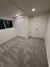 Unfurnished bedroom with carpet floors, a closet, and recessed lighting