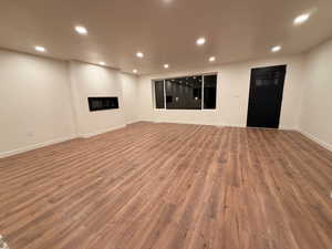 Unfurnished living room featuring recessed lighting and wood finished floors