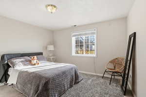 Bedroom featuring carpet flooring and baseboards