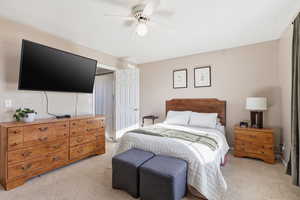 Bedroom featuring light colored carpet and a ceiling fan