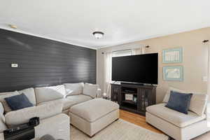 Living room with wood walls and wood finished floors