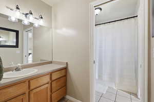Bathroom featuring vanity and light tile patterned floors