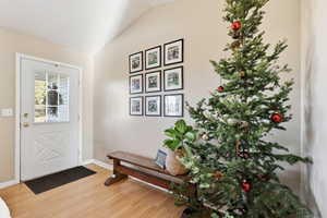 Entrance foyer featuring light wood-style floors and lofted ceiling