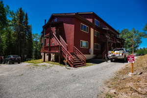 View of front of house featuring stairway and driveway