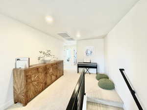 Hall featuring light carpet and recessed lighting