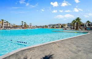 Community pool featuring a patio area and a residential view