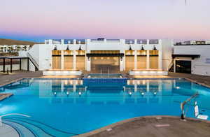 Community pool with stairway, a patio, and a community hot tub