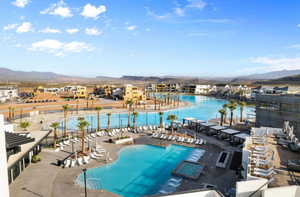 Community pool featuring a mountain view and a patio area