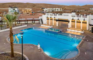 View of pool with a mountain view, a patio, and a pool with connected hot tub