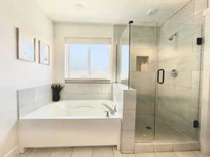 Full bathroom with a garden tub and a shower stall