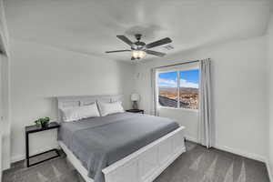 Bedroom featuring dark colored carpet and ceiling fan