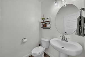 Half bath featuring a sink and toilet