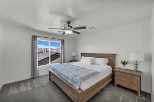 Bedroom with a ceiling fan and carpet