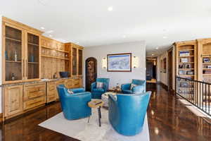 Living area featuring built in features, concrete flooring, recessed lighting, wet bar, and wine cooler
