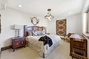 Carpeted bedroom with baseboards and recessed lighting