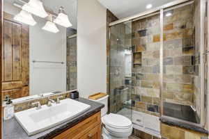 Bathroom featuring vanity and a stall shower
