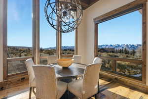 Dining space with a chandelier, a mountain view, and hardwood / wood-style floors