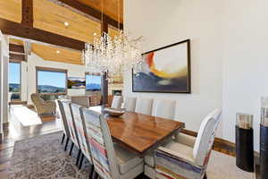 Dining space with a chandelier and dark wood finished floors