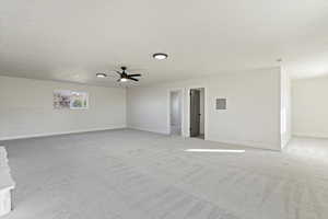 Unfurnished room featuring light carpet and a ceiling fan