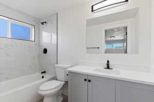 Bathroom with shower / bath combination and vanity