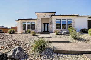 Prairie-style home featuring stone siding