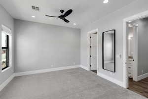 Unfurnished bedroom with light colored carpet, recessed lighting, and ceiling fan