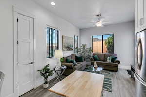 Living room featuring light wood-style floors and ceiling fan