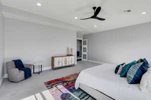 Carpeted bedroom with ceiling fan and recessed lighting