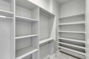 Spacious closet with light carpet