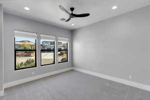 Spare room with ceiling fan, light colored carpet, and recessed lighting