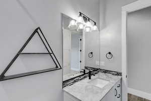 Bathroom featuring vanity and baseboards