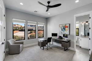 Home office with a ceiling fan, healthy amount of natural light, light carpet, and recessed lighting