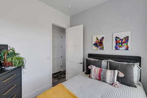 Bedroom with baseboards and wood finished floors