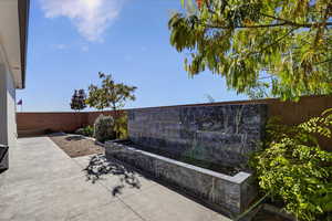 Fenced backyard with a patio