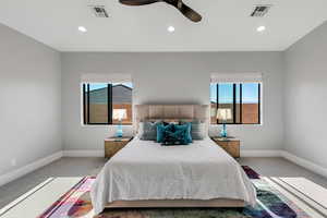 Carpeted bedroom featuring a ceiling fan, multiple windows, and recessed lighting