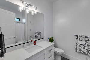 Bathroom with vanity and a shower with shower curtain