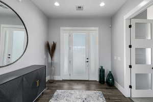 Foyer entrance with wood tiled floors and recessed lighting