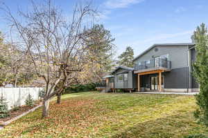 Back of property with a patio, brick siding, and a wooden deck